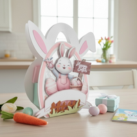 Easter-themed decorative display with a rabbit figure and cards on a table.